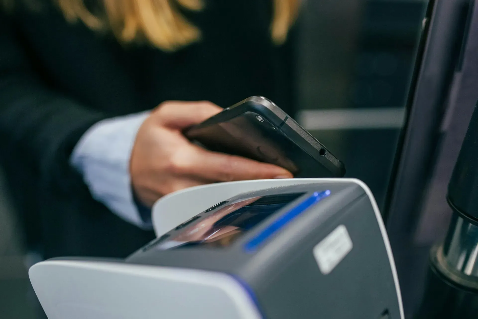 Man paying with phone on checkout Man paying with phone on checkout